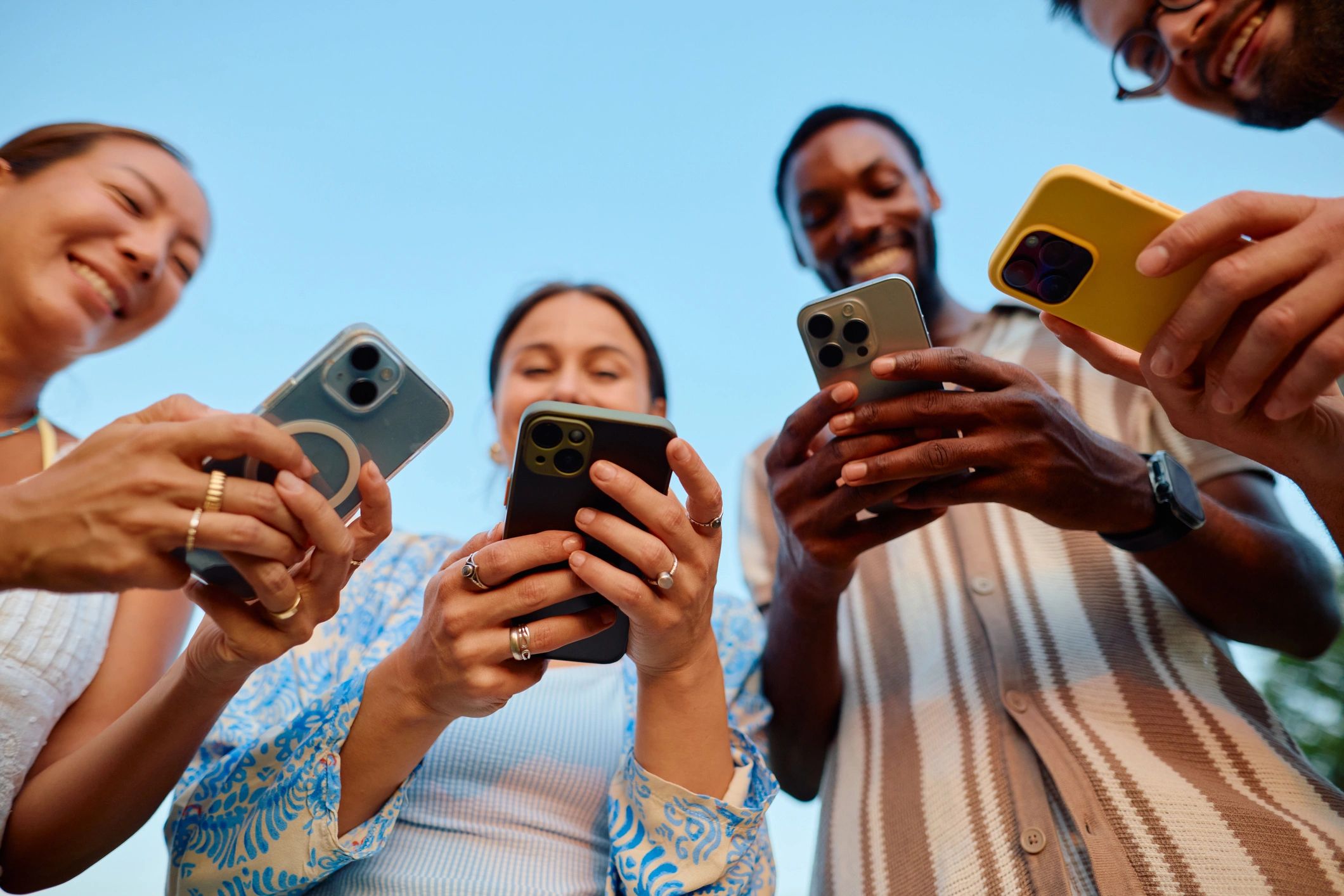 diverse people using social media on mobile devices